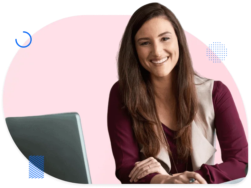 Smiling woman at desk with laptop, representing the education sector