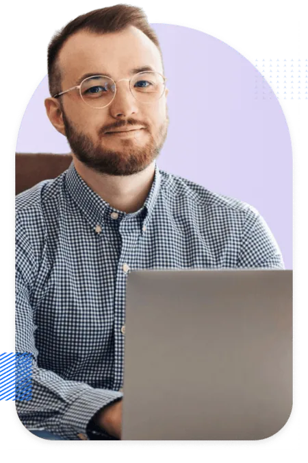 Pardot consultant at his laptop, smiling into the camera
