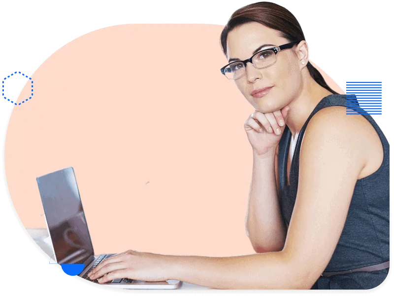 Focused marketing professional working on laptop with confident expression, representing marketing managers