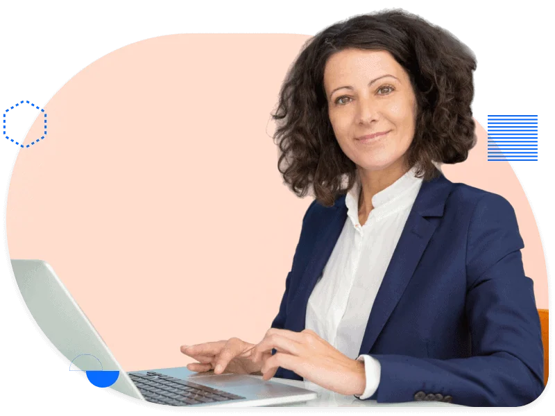 Businesswoman in blazer working on laptop, representing the professional services industry