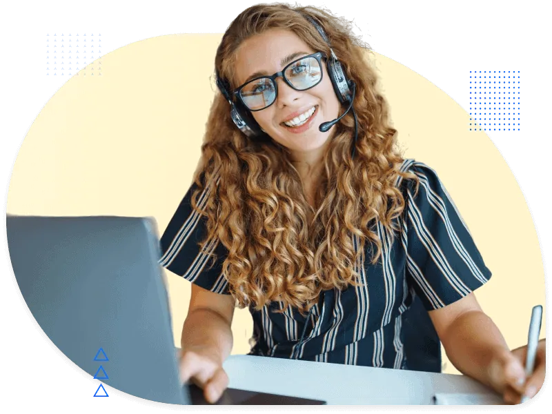 Smiling man in casual shirt on a phone call while working on laptop, representing sales