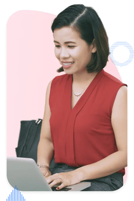 Pardot consultant smiling while working on a laptop