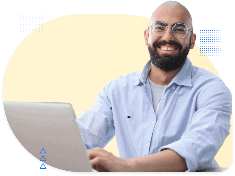 Smiling man at laptop, representing the technology sector
